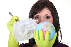 woman dusting a globe