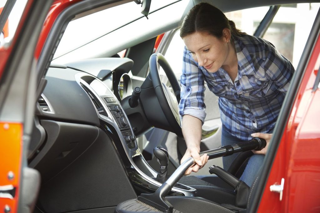 woman cleaning interior of car