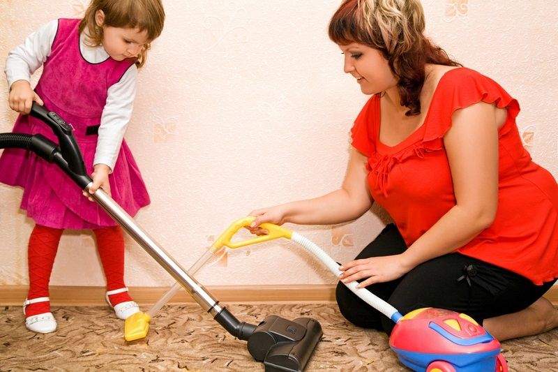 mother and child vacuuming