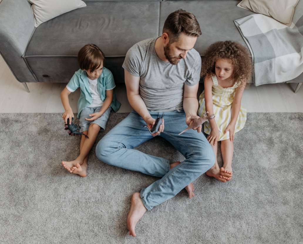 dad on carpet with kids